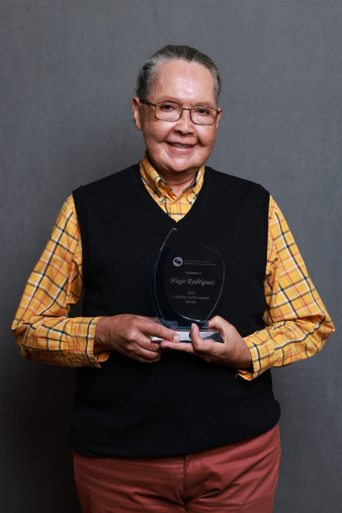 Hugo Rodriguez holding his Lifetime Achievement Award.